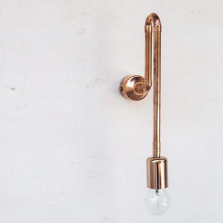 Copper wall-mounted light fixture on a white background